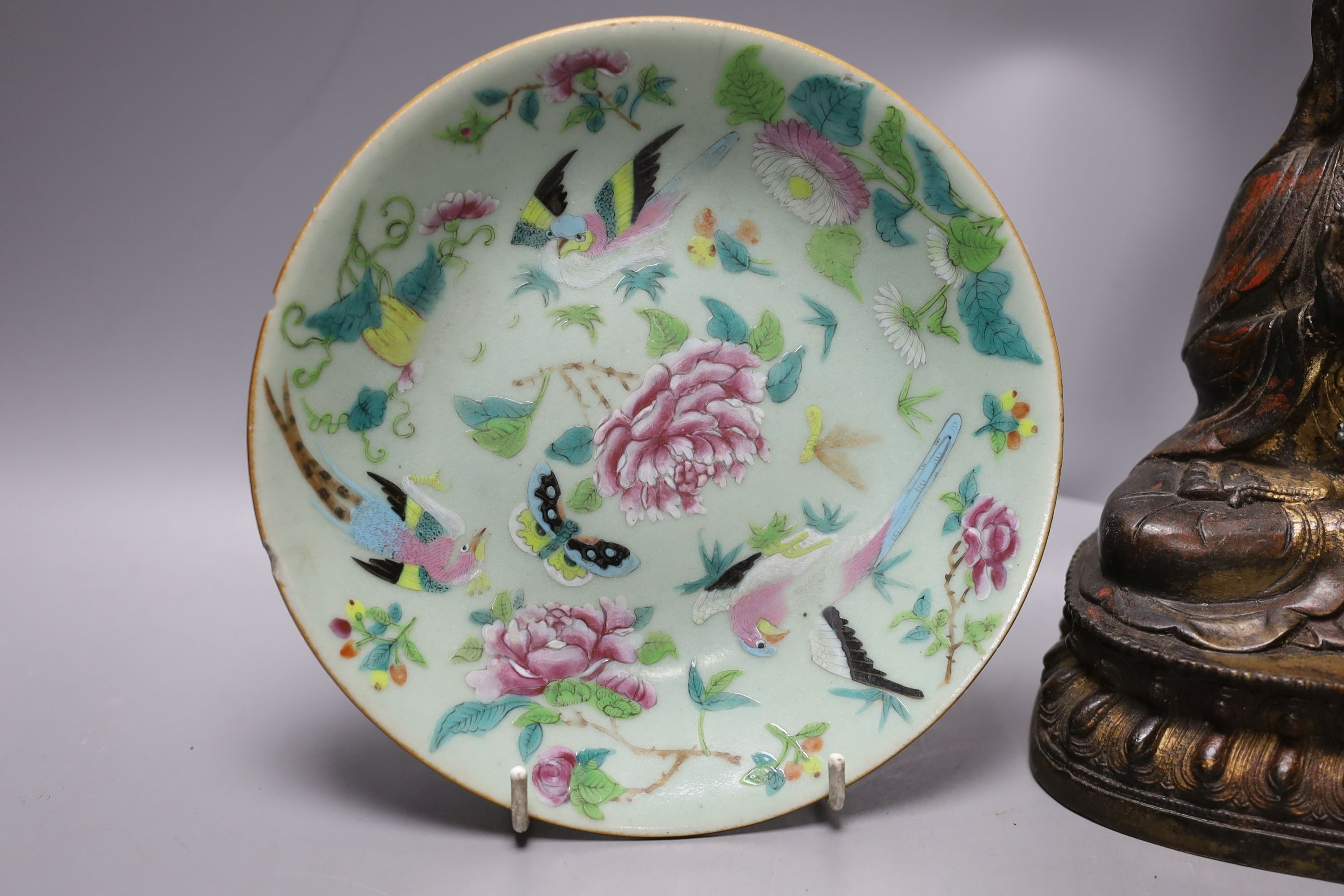 A Chinese iron alloy figure of Guanyin, 23cm tall, together with a Chinese Ding type bowl and a Chinese enamelled porcelain dish (3)